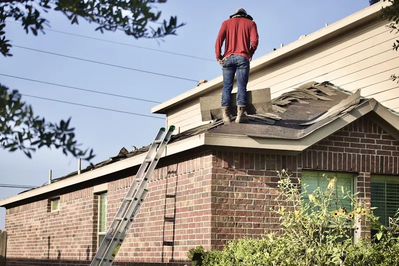 Professional roofer working on a residential roof in Avenue D District